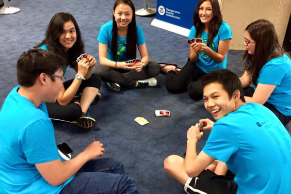 youth symphony playing cards in airport