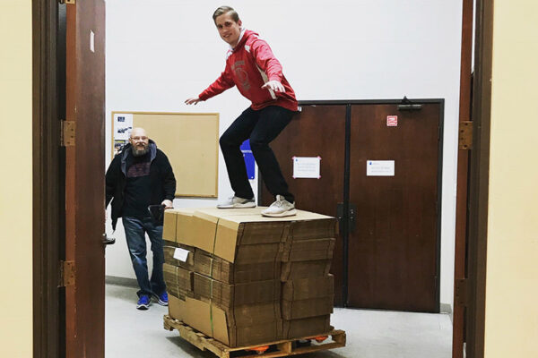 student surfing on boxes
