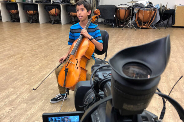 young celloist being filmed
